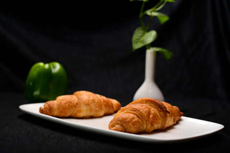 fresh bread in white plate , green peppers.の写真素材