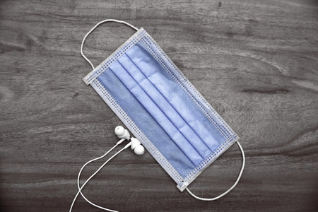 Medical blue face mask with wooden background.