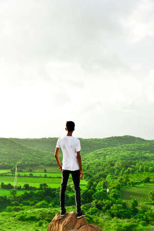 Man standing on top of mountain and watching nature greenery .Beautiful moment the miracle of nature.の写真素材
