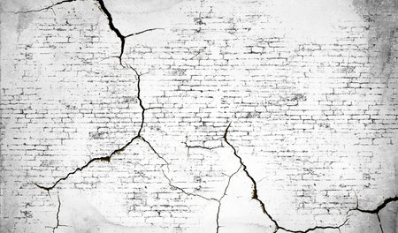 Cracked brick texture in black and white with intersecting lines resembling a map.の写真素材