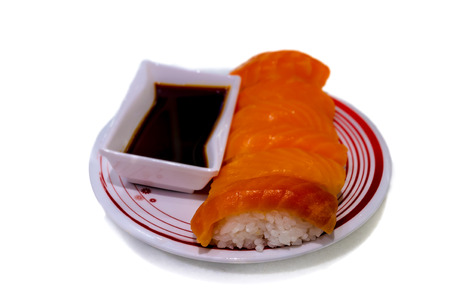 Salmon sushi set with shoyu sauce on isolated backgroundの写真素材