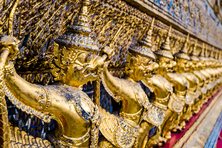 Golden garuda pattern standing at wat pha kaewの写真素材