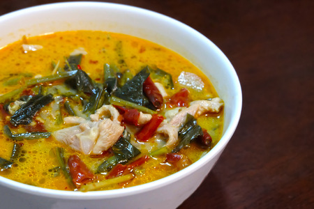 Tom yum soup with chicken on wooden tableの写真素材