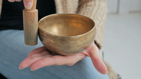 Close up shot of nepal singing bowl in woman's hand. Meditation and relax conceptの写真素材