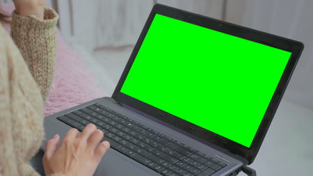 Woman using laptop with green screen. Business, communication, freelance and internet conceptの写真素材