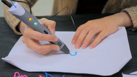 Close up shot. Woman using 3D printing pen. Future and technology concept