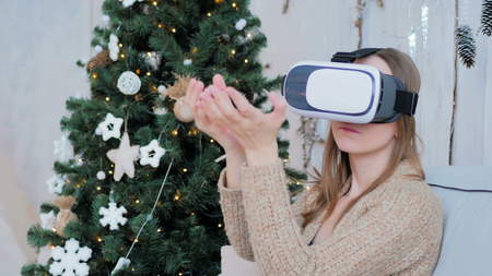 Woman using virtual reality glasses. Virtual reality mask. VR. Christmas, future and technology conceptの写真素材