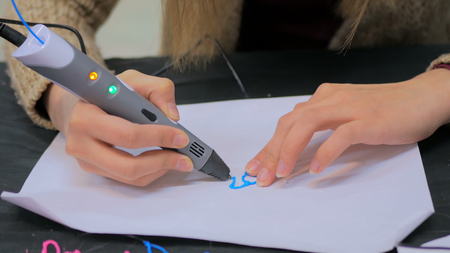 Close up shot. Woman using 3D printing pen. Future and technology conceptの写真素材