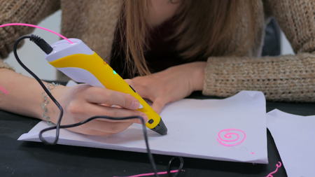 Close up shot. Woman using 3D printing pen. Future and technology conceptの写真素材