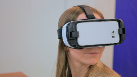Virtual reality game. Young woman using virtual reality glasses. VR
