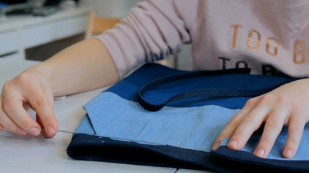 Professional tailor, designer measuring suit jacket for sewing at atelier. Fashion and tailoring concept. Dolly shotの写真素材