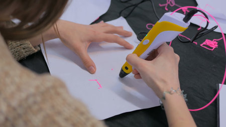 Close up shot. Woman using 3D printing pen. Future and technology concept