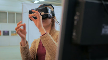 Virtual reality game. Young woman using virtual reality glasses. VRの写真素材