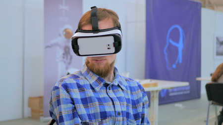 Virtual reality game. Young man using virtual reality glasses. VRの写真素材