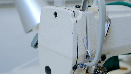 Part of sewing machine at atelier. Fashion and tailoring concept