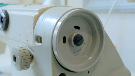 Part of sewing machine at atelier. Fashion and tailoring concept