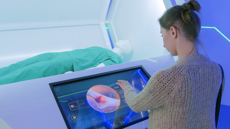 MOSCOW, RUSSIA - SEPTEMBER 10, 2017: Smart City Exhibition. Woman using interactive touchscreen display with medical information at modern technology showのeditorial素材