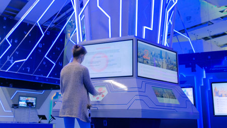 MOSCOW, RUSSIA - JULY 12, 2017: Moscow Urban Forum. Woman using interactive touchscreen stand and...