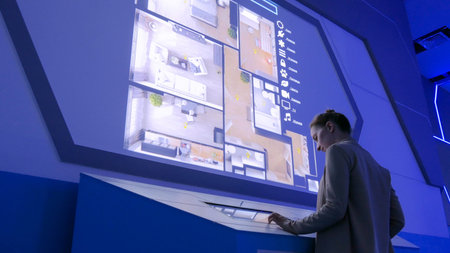 MOSCOW, RUSSIA - July 30, 2018: Smart City Exhibition. Woman using interactive touchscreen display...