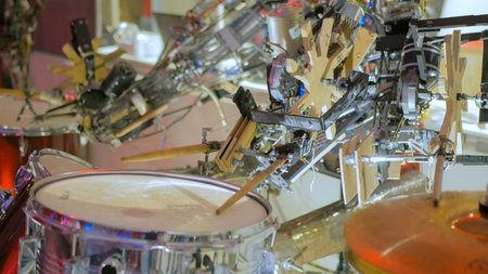 Vintage robot playing drums. Closeup shot of robot hand with drumstick. Future and robotic concept