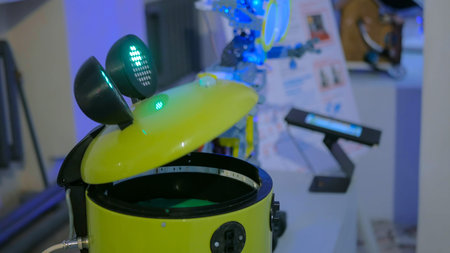 Funny yellow bucket robot at technology exhibition. Future and robotic concept