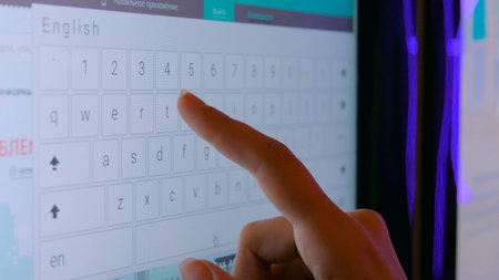 Woman using interactive touchscreen display at modern technology show