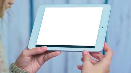 Mock up, template and technology concept - woman looking at horizontal tablet computer with white...