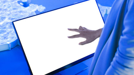 Woman using white empty interactive touchscreen display at modern technology exhibition - close up...