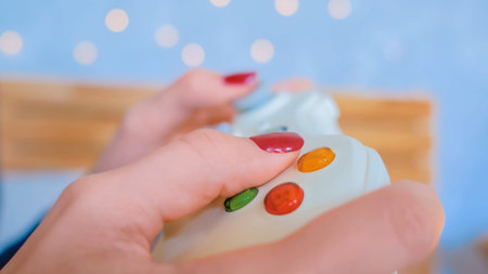 Christmas, gaming, holiday, celebration and technology concept - woman holding gamepad and playing...