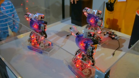 Humanoid robots with colourful illumination dancing at technology exhibition. Future and robotic conceptの写真素材