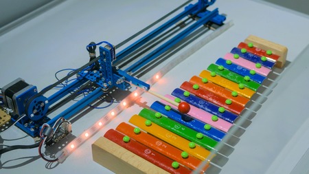 Robot playing on colorful xylophone at technology exhibition. Future and robotic conceptの写真素材