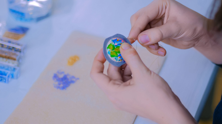 Professional jewelry designer making handmade brooch with beads in studio, workshop. Fashion, creativity and handmade conceptの写真素材