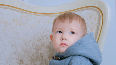 Portrait of pensive little boy at home. Family, childhood and leisure concept