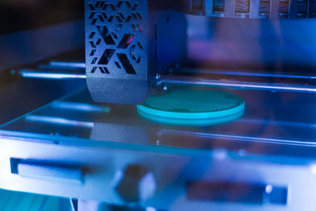 Automatic three dimensional 3D printer machine printing flat plastic model at modern technology...