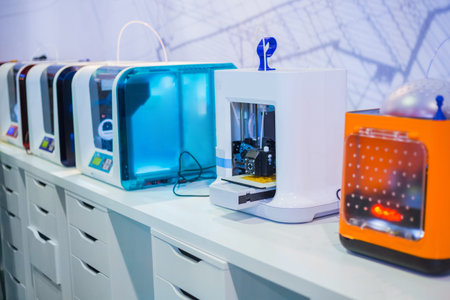 Automatic 3D printers in row during work at modern technology exhibition. 3D printing, additive...