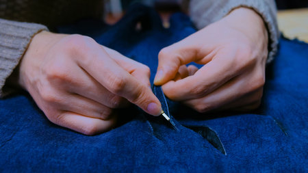 Professional male skinner, furrier working with beaver fur skin at atelier, workshop. Fashion and...