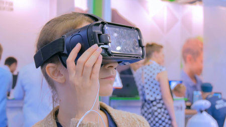 Young woman using virtual reality glasses. Entertainment and technology concept