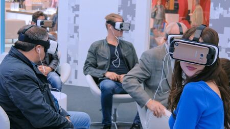 MOSCOW, RUSSIA - July 30, 2018: Moscow Urban Forum. Group of people using virtual reality headset at exhibition, show. VR cinema conceptのeditorial素材