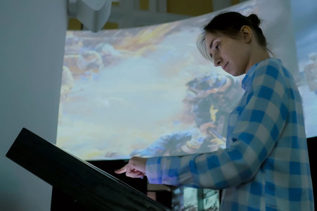 Woman using electronic multimedia kiosk with interactive touchscreen display at modern history...