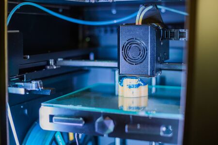 3D printer prints physical 3D model with plastic wire filament at modern technology exhibition. Additive technologies, science and futuristic conceptの写真素材