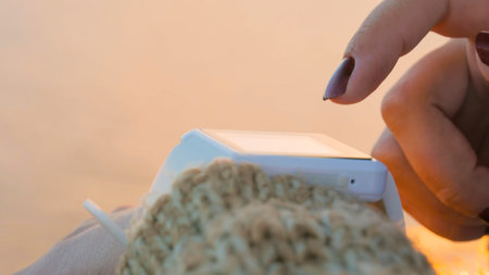 Woman using wearable smartwatch computer device on deck of cruise ship at sunset. Sunset light, golden hour. Technology and journey conceptの写真素材