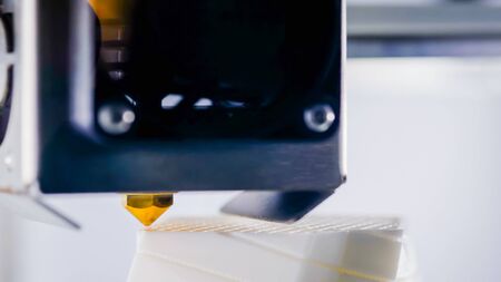 3D printer prints physical 3D model with plastic wire filament at modern technology exhibition. Additive technologies, science and futuristic conceptの写真素材