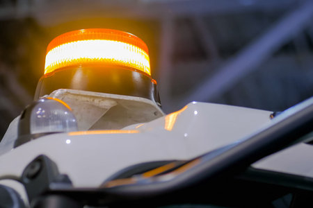 Close up of warning orange beacon flashing on roof of emergency, support and service vehicle....
