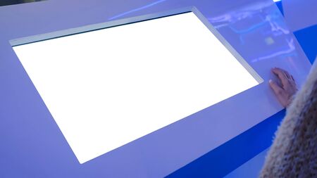 White screen, mockup, science, copyspace, template, isolated, technology concept. Woman looking at blank white display of interactive kiosk at exhibition or museum with futuristic sci-fi interiorの写真素材