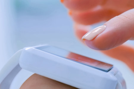 Young woman using white wearable smartwatch computer device in bright white room or office -...