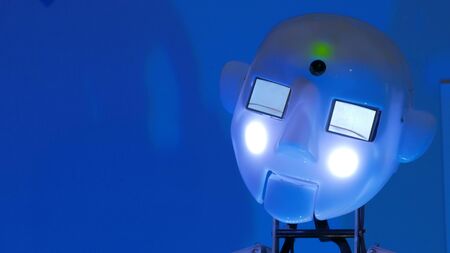Portrait of funny humanoid robot at technology exhibition. Close up shot of robot head. Future and robotic conceptの写真素材