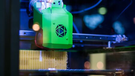 Three dimensional printing machine printing 3D plastic model at modern technology exhibition. 4.0 industrial revolution, additive manufacturing, 3D printing and robotic automation technology conceptの写真素材