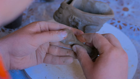 Clay workshop: man making mug in pottery studio. Handmade, art and study conceptの写真素材