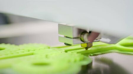 3D printer prints physical 3D model with plastic wire filament at modern technology exhibition. Additive technologies, science and futuristic conceptの写真素材