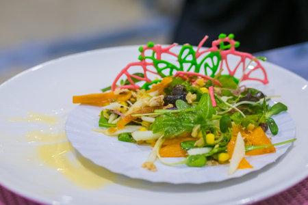 Delicious fresh exotic salad with natural ingredients for sale on white plate at cuisine of...